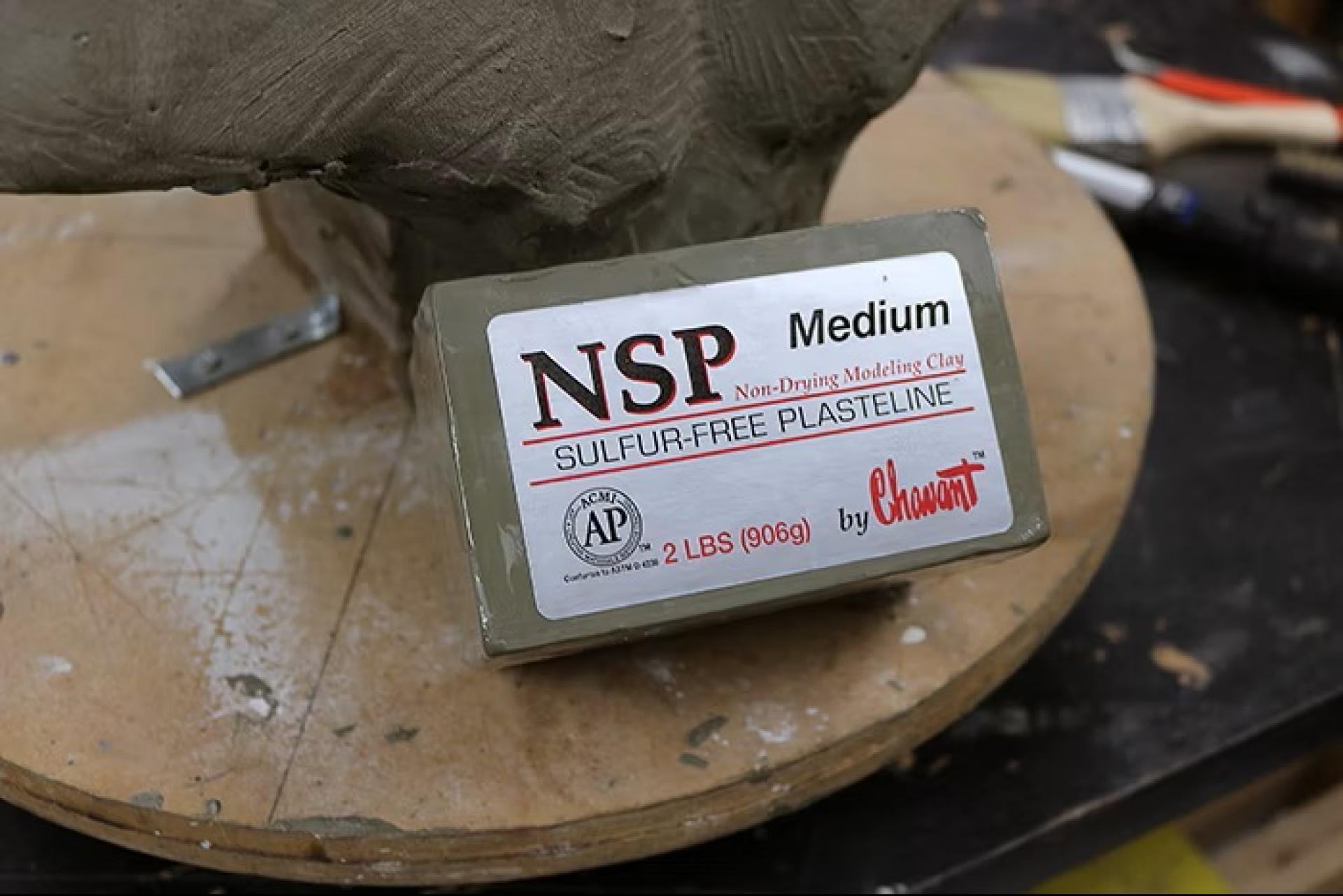 Block of NSP medium sulfur-free plasteline clay on a sculpting stand.