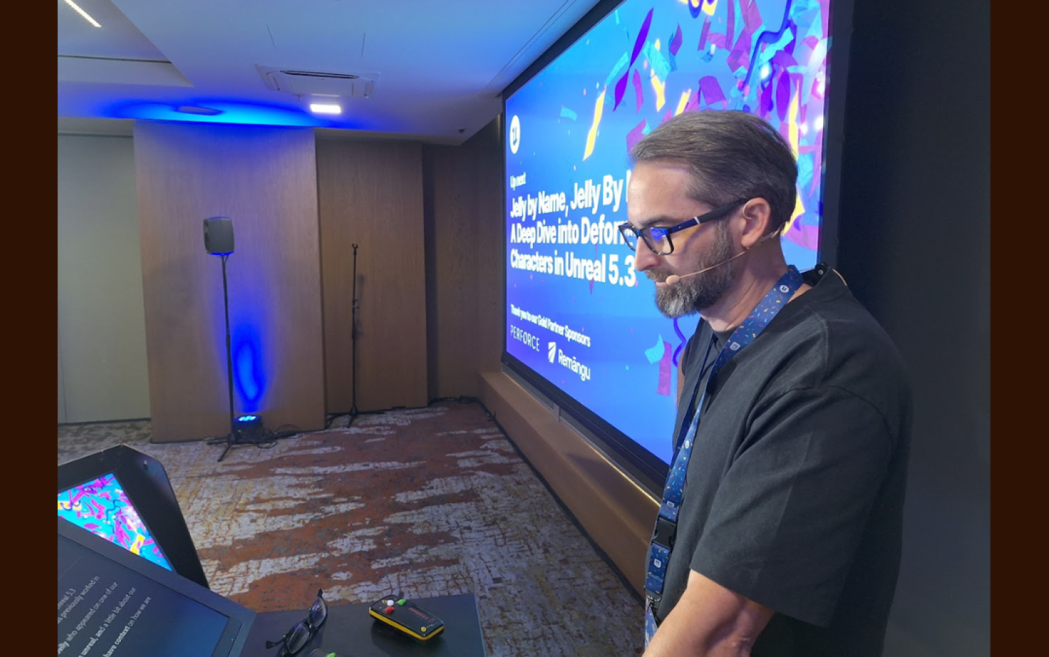 Person standing near a screen displaying a presentation titled “Jelly by Name, Jelly by Nature” at an event.
