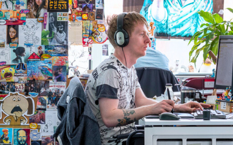 Desk filled with creative materials and colorful wall decorations.