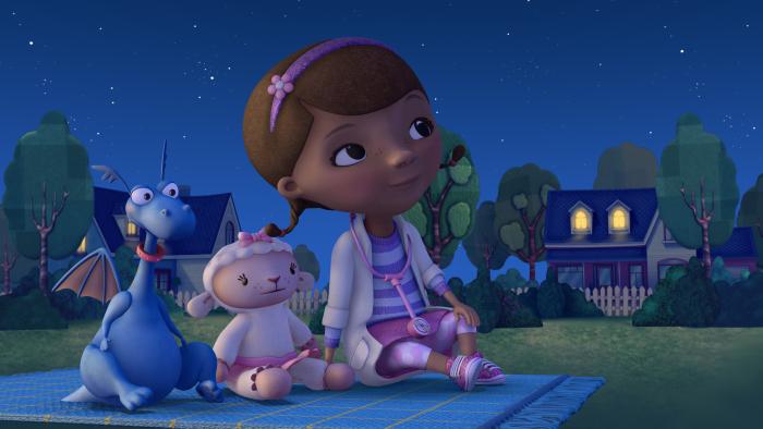 Doc McStuffins on a picnic blanket with Stuffy and Lambie in the evening outside her home