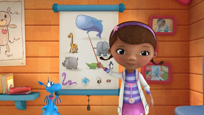 Doc McStuffins pointing at a picture of a whale on a chart