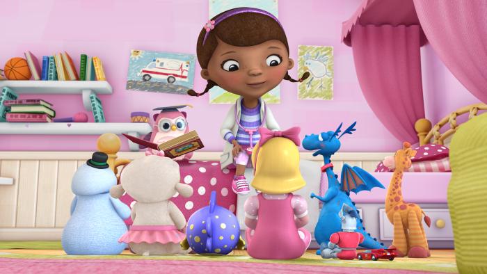 Doc McStuffins with her toy friends sitting around her in her room
