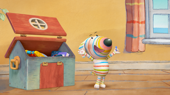 Dylan's Playtime Adventures: A character stands beside an open toy chest filled with colorful toys.