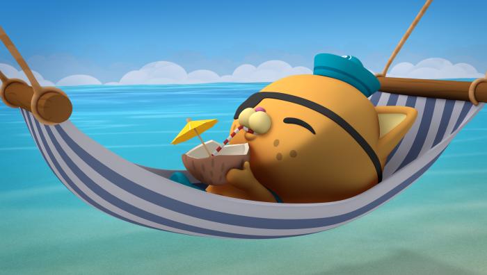 Kwazii relaxing and sipping a drink in a hammock