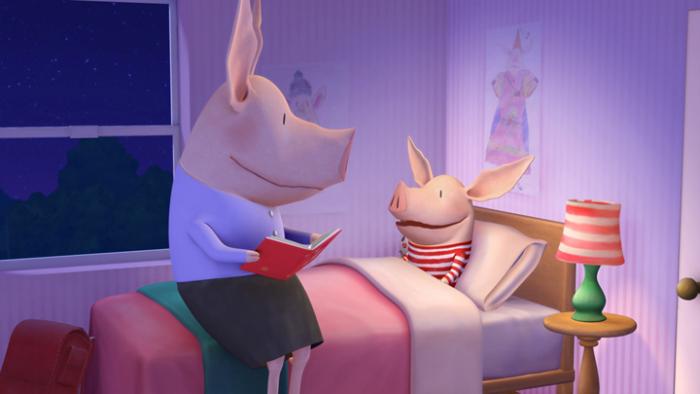 Olivia in her bed with her mother reading her a book.