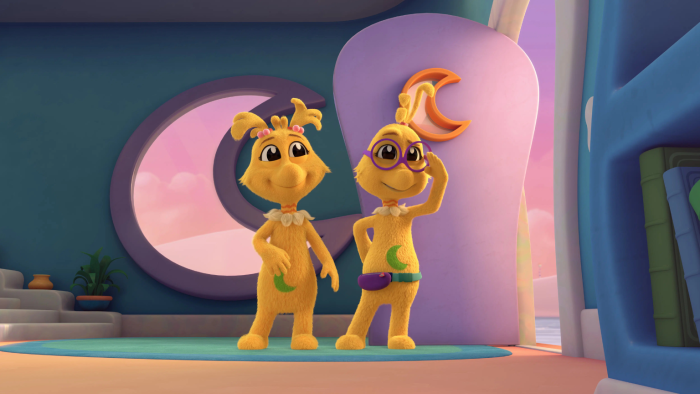 Two Sneetches indoors near a pink structure; both have moon shapes on their bellies. The one on the right is wearing glasses.